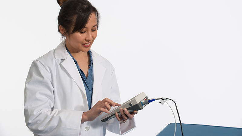 Clinician performing ABR test using Bio-logic NavPRO ONE portable AEP device.