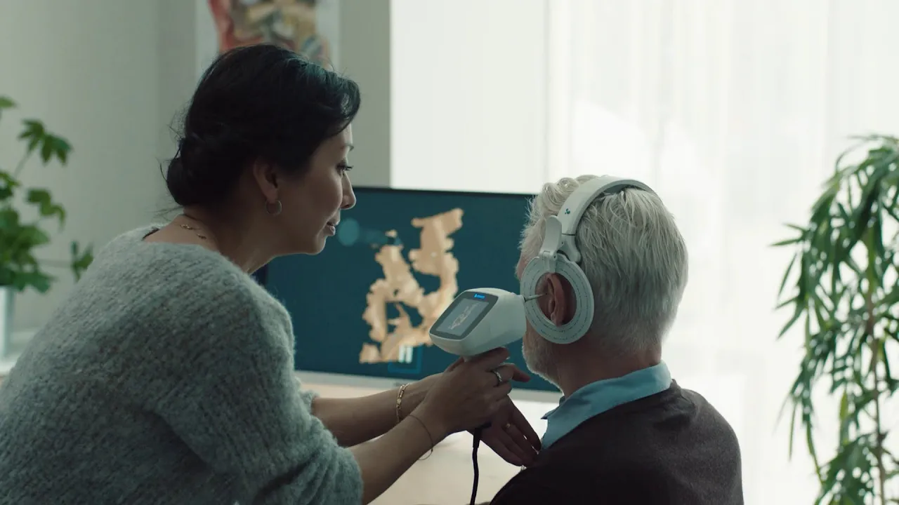 Clinician performing 3D ear scanning with a noninvasive otoscope for digital ear modeling