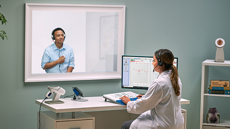 .Audiologist using Madsen Astera2 diagnostic audiometry equipment for PC based audiometric testing during patient hearing assessment.
